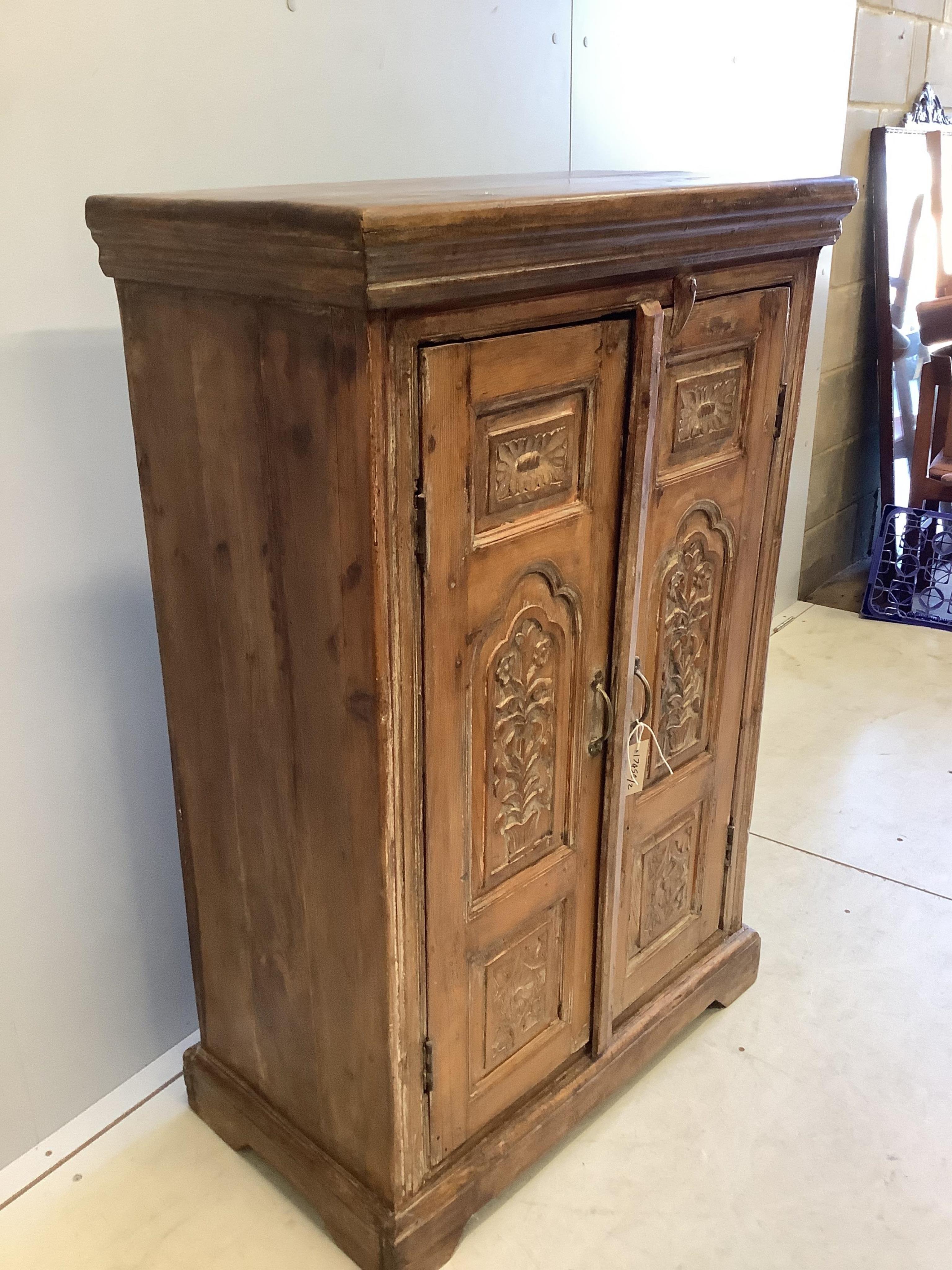 An Indonesian carved hardwood two door side cabinet, width 74cm, depth 39cm, height 112cm